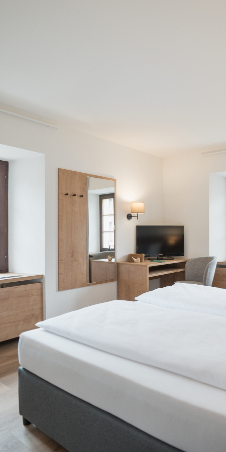 Camera doppia all’Hotel Brocco & Posta a San Bernardino con dettagli in legno e arredamento semplice