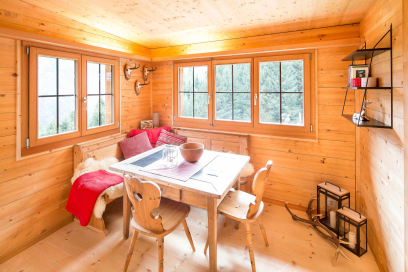 Gemütlicher Essbereich mit Eckbank und Holzmöbeln in der Berghütte Pundelon